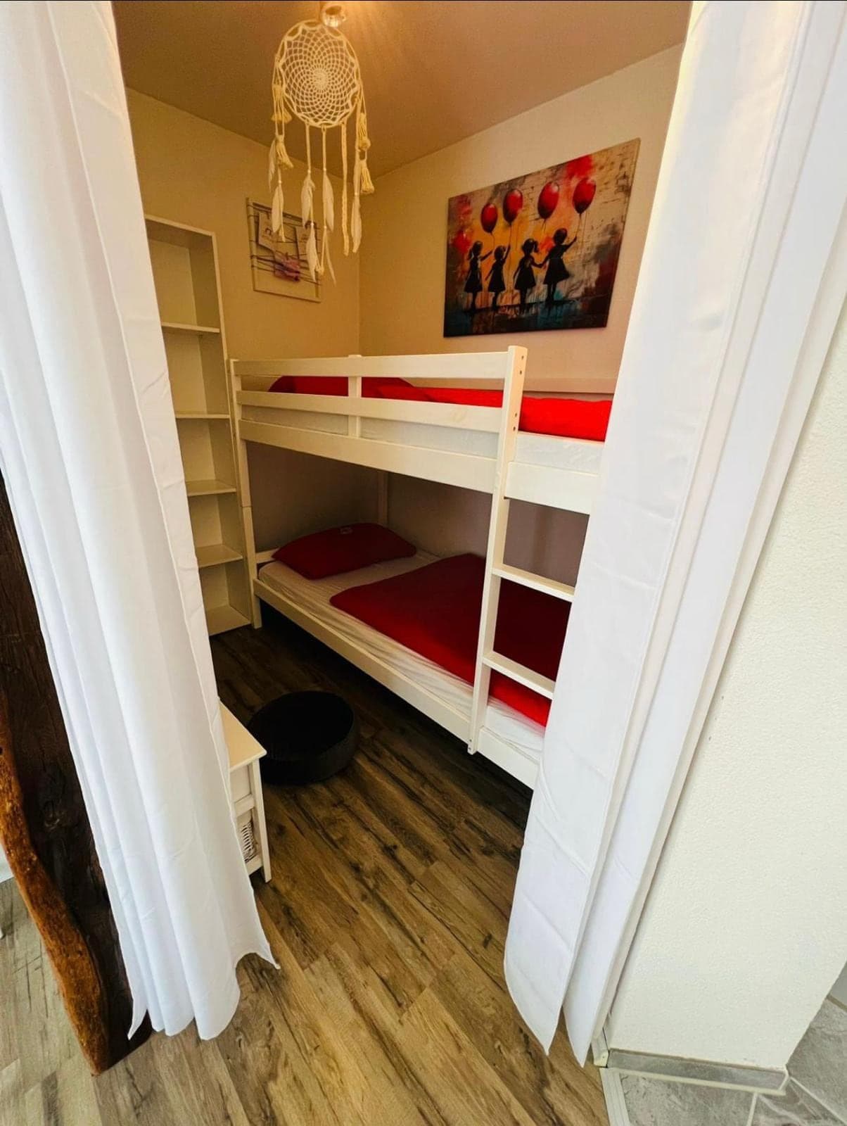 Abgetrennter Kinderbereich mit Etagenbett hinter Vorhang